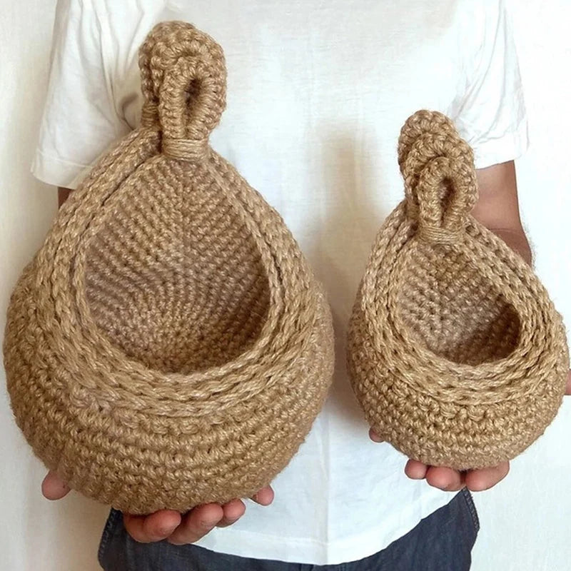 Two sizes of woven wall baskets held in hand
