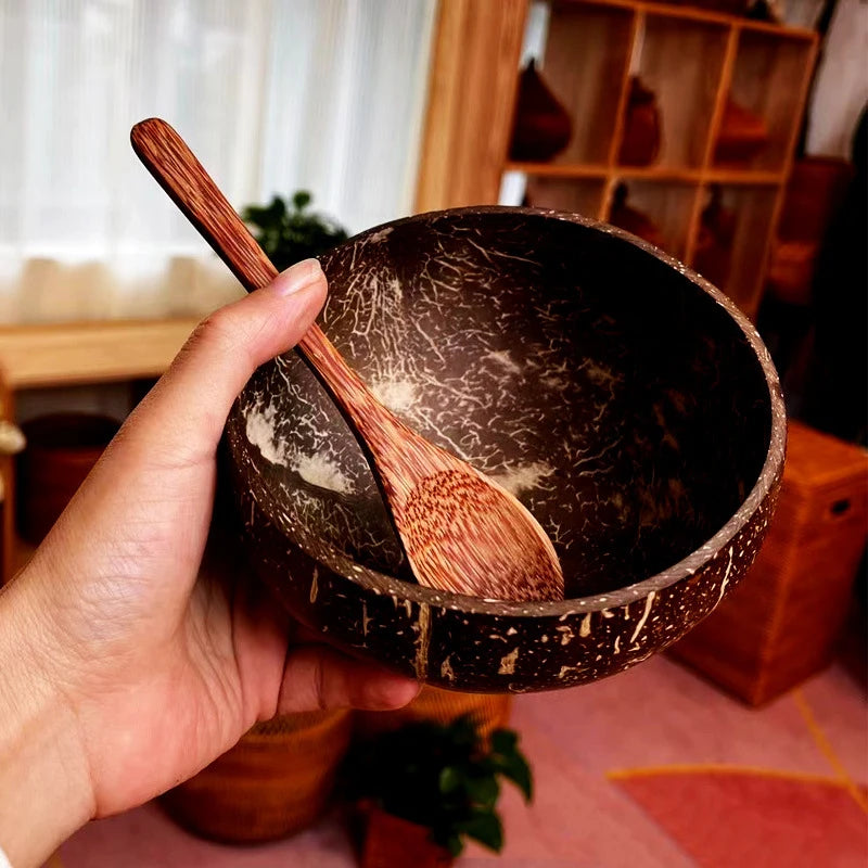 Handcrafted coconut bowl with eco-friendly wooden spoon on tabletop