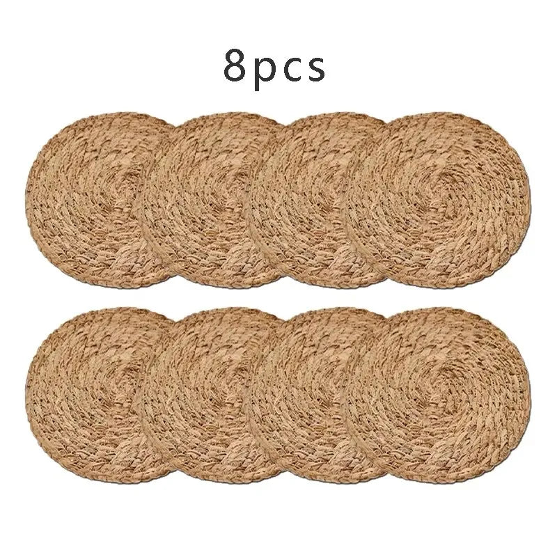 Hand‑woven round rattan placemat with linen weave pattern on wooden table