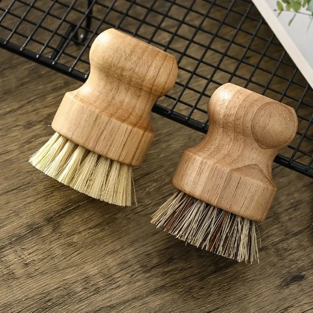 Two eco kitchen brushes with wooden handles on a countertop