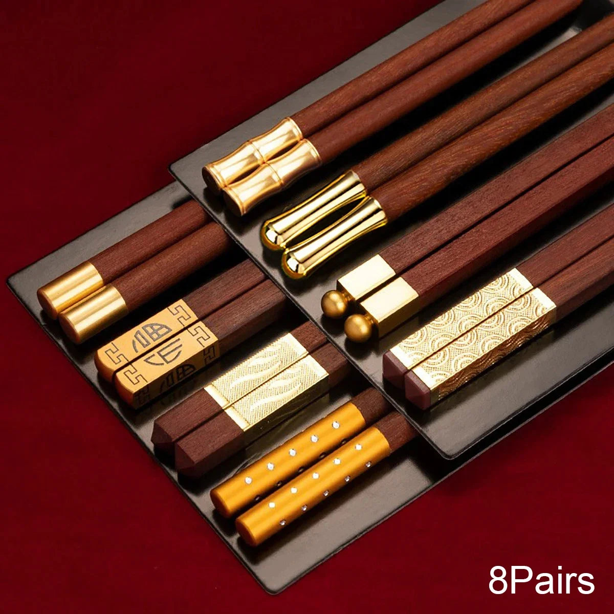 Close-up of red wood chopsticks with square tips and gold inlay