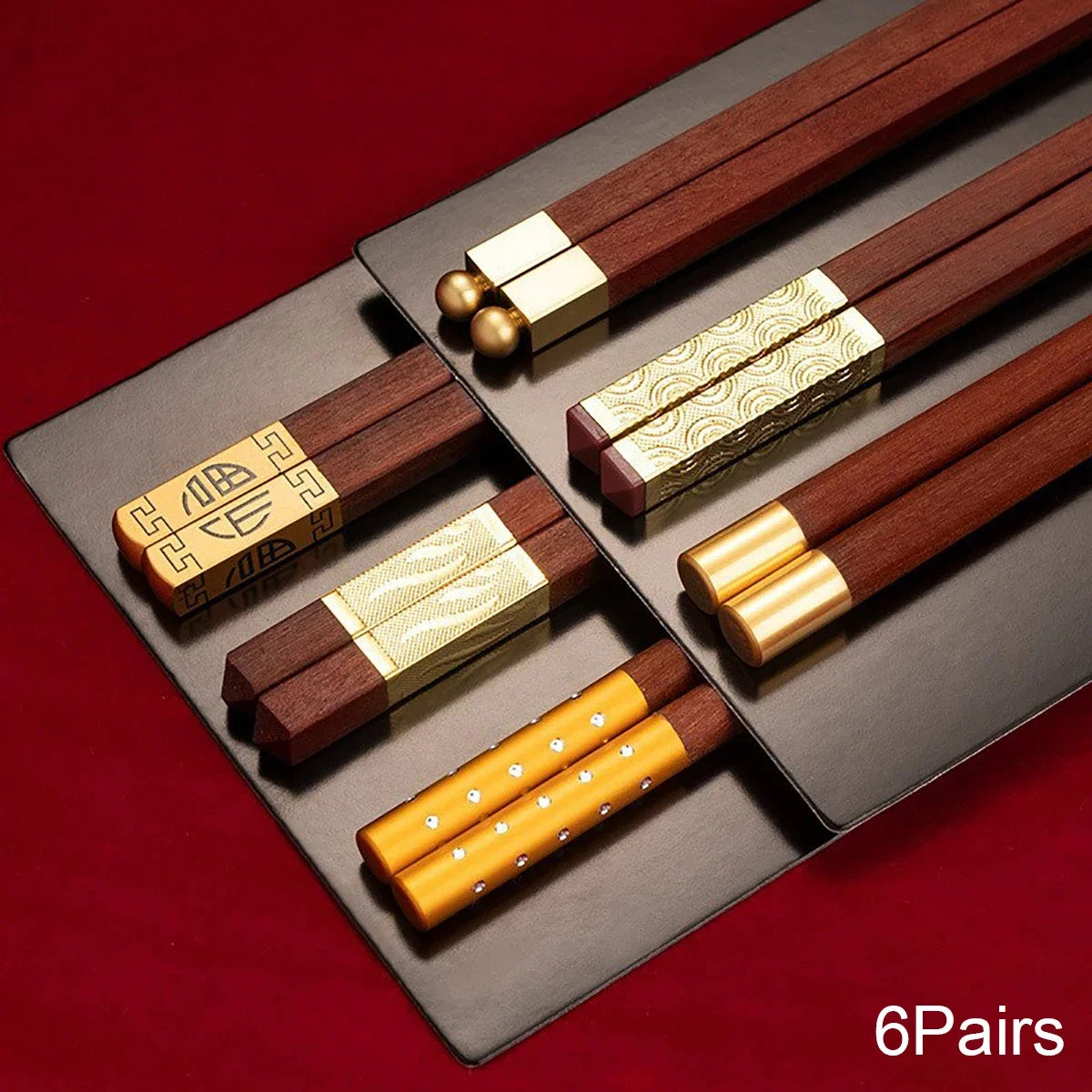 Close-up of red wood chopsticks with square tips and gold inlay