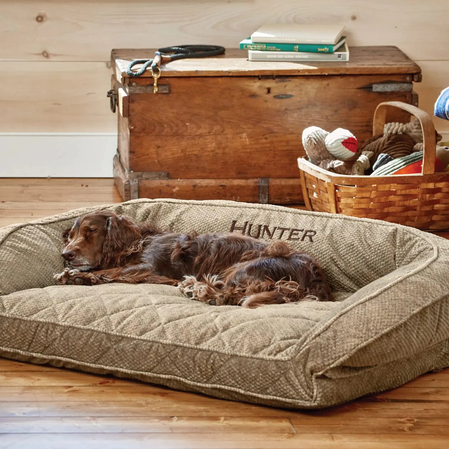 Dog relaxing on eco-friendly orthopedic dog bed with brown tweed cover