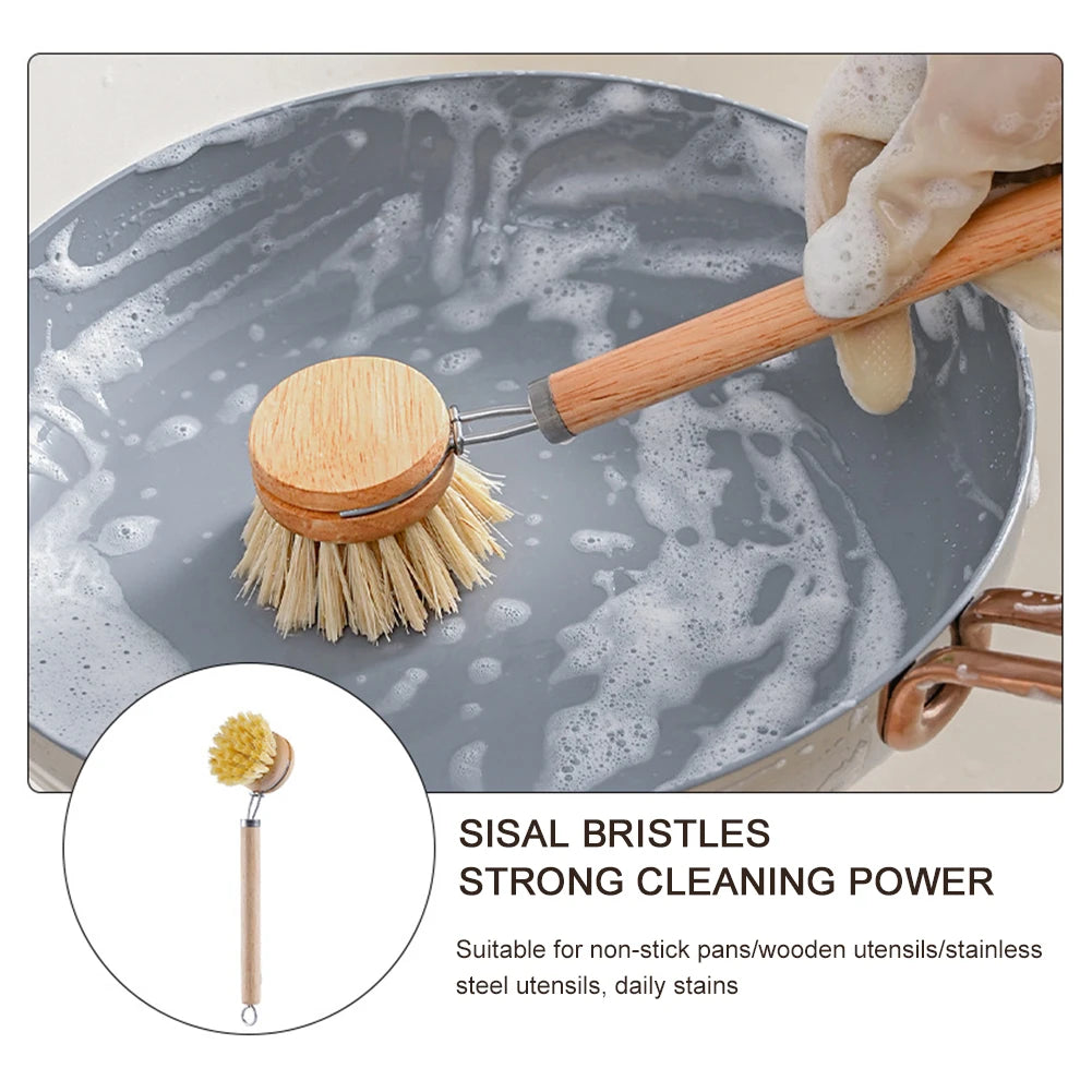 Hand using wooden brush to clean frying pan