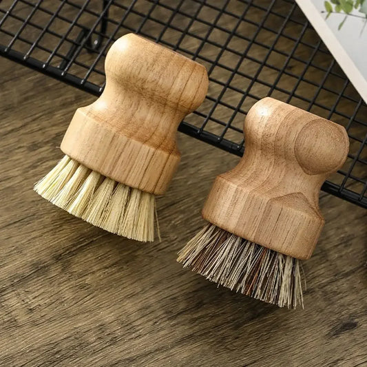 Two eco kitchen brushes with wooden handles on a countertop